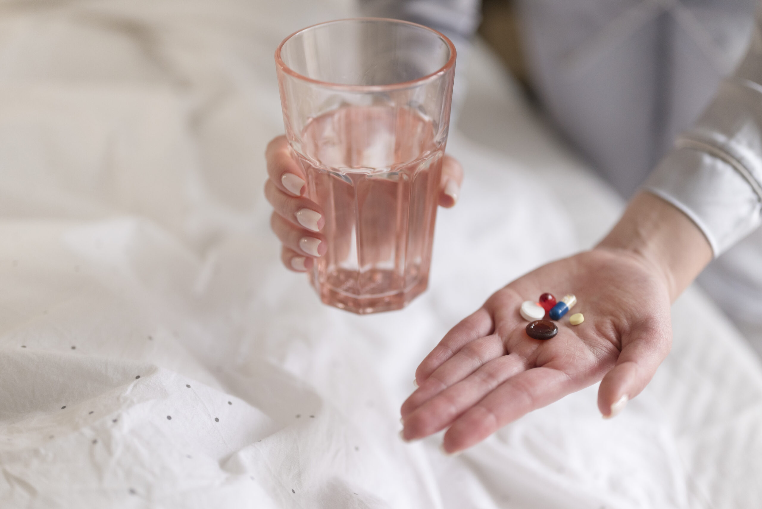 image of hand holding pills